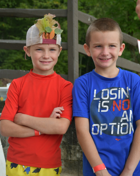 Two kids at camp smiling 